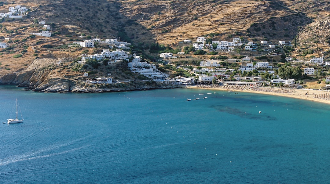 an aerial view of a beach with a boat in the water